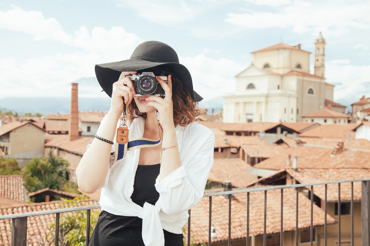 a woman taking photographs in a popular attraction